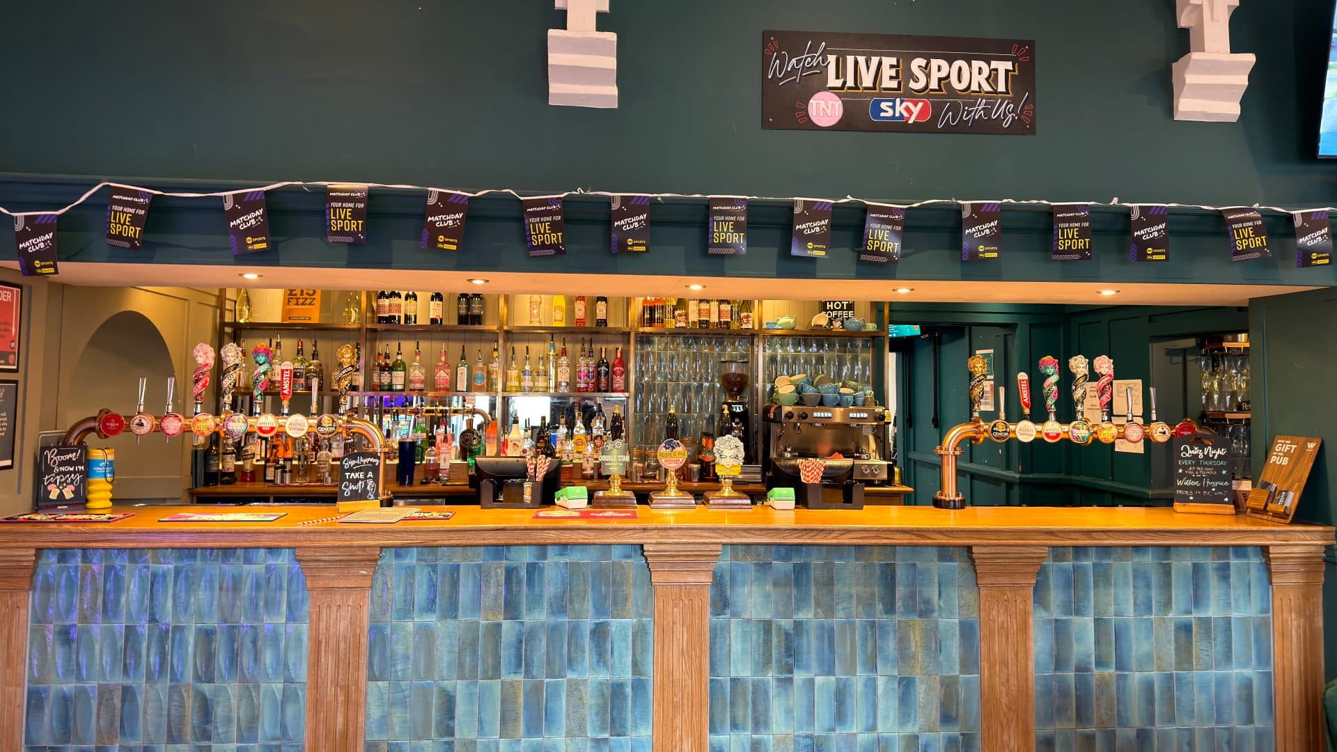 Beer being poured at the bar inside The Old School House pub in Stony Stratford.