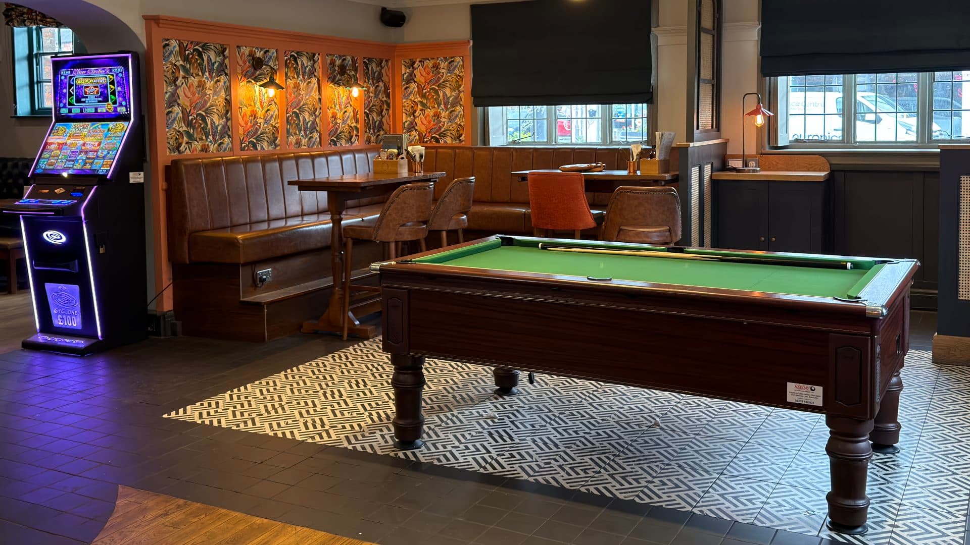 Pool table and fruit machine inside The Old School House pub in Stony Stratford.